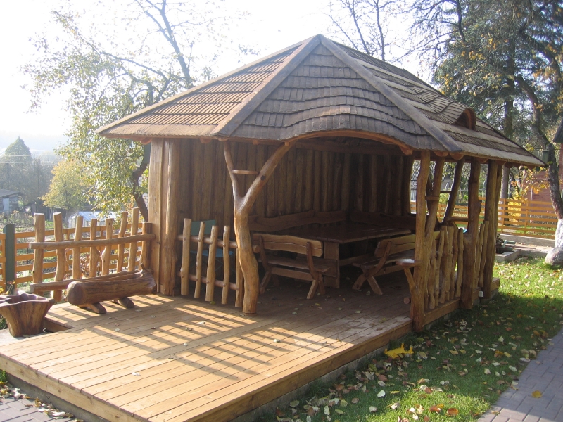 Gazebo with a deck, a board wall and a log bench No. 15-4